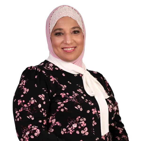 Dr. Mona Orady in a black and pink floral outfit with a beaded cream and pink colored hijab.