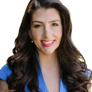 OB/GYN and fertility specialist Dr. Aimee Eyvazzadeh. Dr. Aimee is a Caucasian woman with long dark hair wearing a blue cap-sleeve dress with a v-neck.