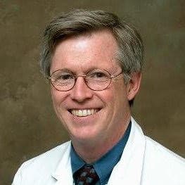 Dr. Bruce Lessey, a white man with lightly graying hair, wearing glasses and smiling.