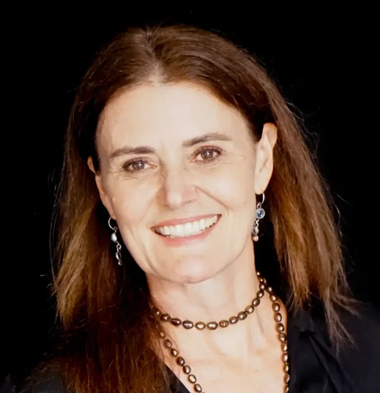 Dr. Shanit Mohling, a Caucasian woman with thick long dark brown hair parted in the middle and hazel eyes, smiling.